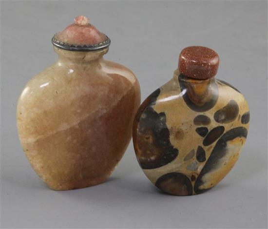 A Chinese pudding stone snuff bottle and a Chinese crystal snuff bottle, 19th century, 6.4cm and 7.7cm incl. stoppers